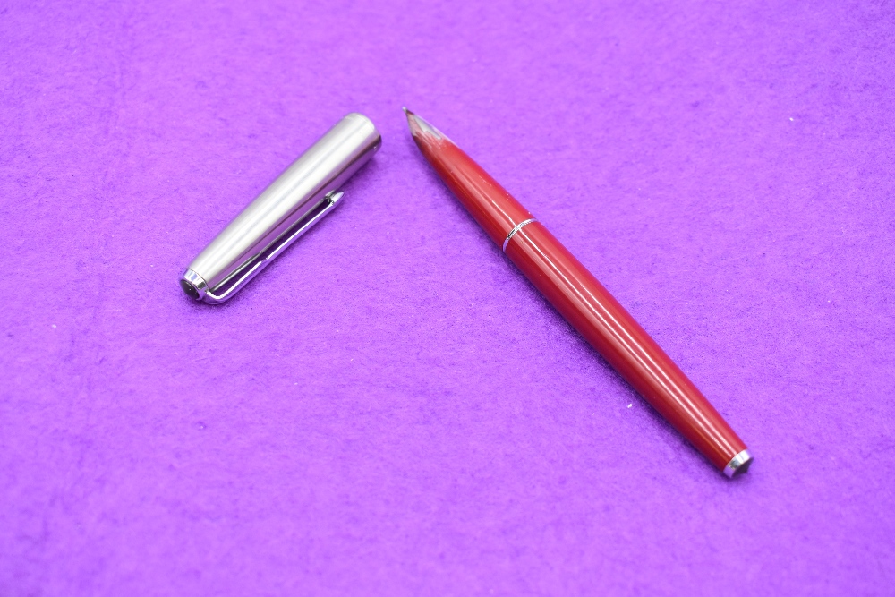 A Parker 61 in red with a brushed metal cap