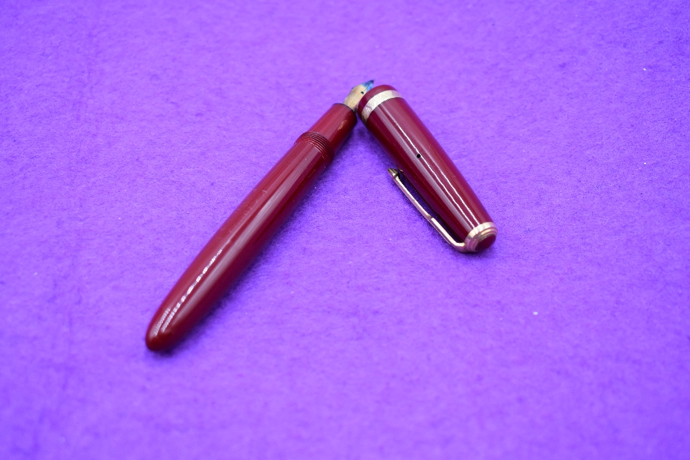 A Parker Duofold in red with single decorative band to cap