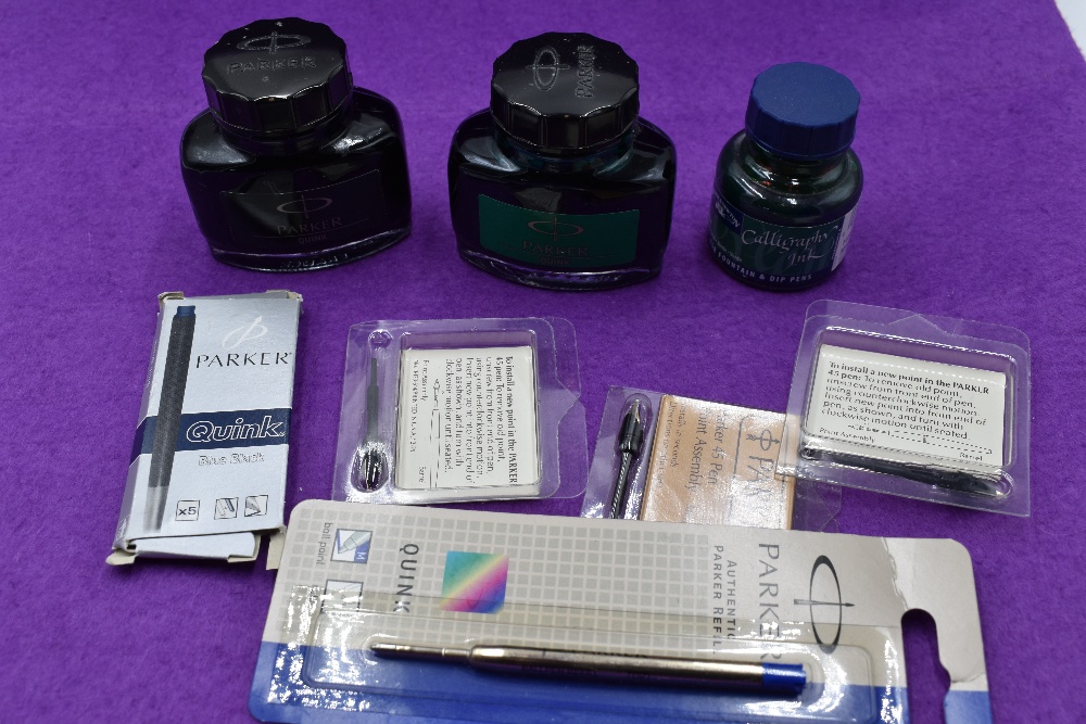 Two bottles of Parker Quink ink, a botthe of caligraphy ink, pen nibs, pencil leads and cartridges