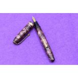 A Conway Stewart 84 fountain pen in pink marble, lever fill, one broad band to cap