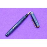 A Conway Stewart 36 fountain pen, lever fill, in pale and dark blue narrow straited pattern, one