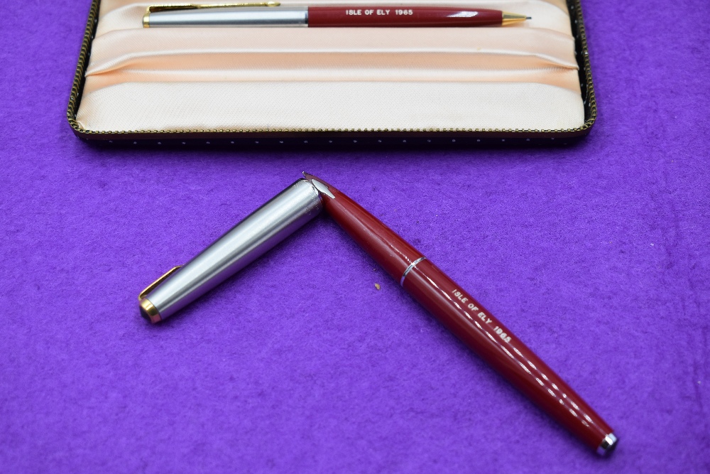 A boxed Parker 61 fountain pen and propelling pencil set, in red with brushed steel cap with gold - Image 2 of 2