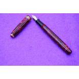 A Conway Stewart 300/094 fountain pen in red marble, lever fill, two narrow and one broad band to