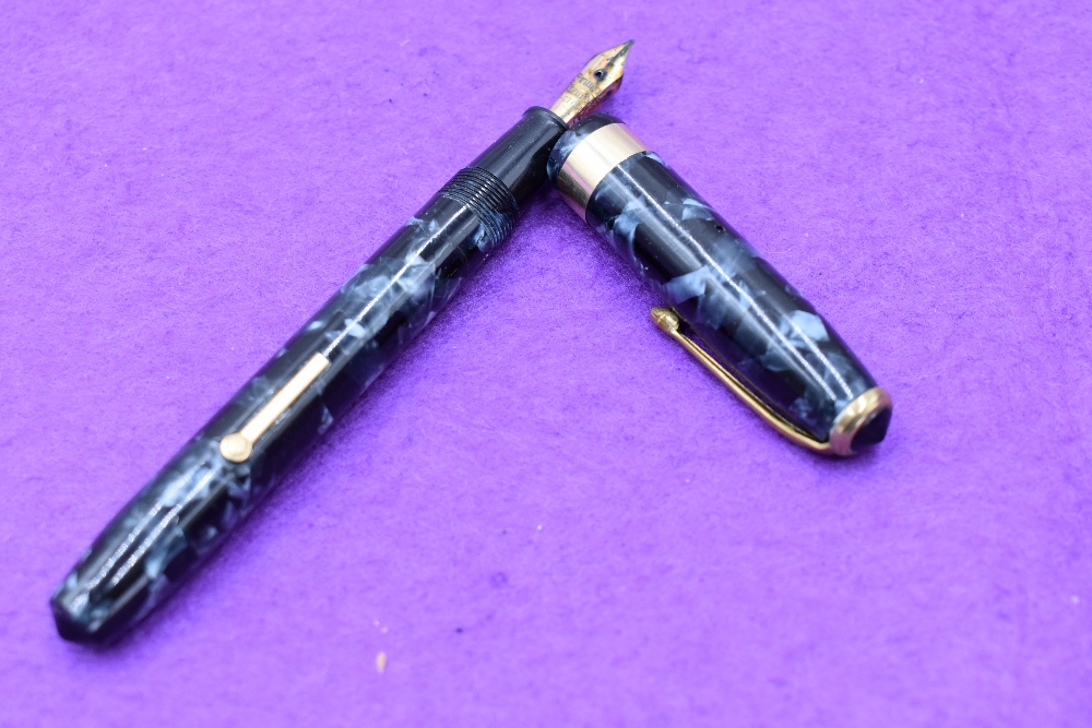 A Conway Stewart 27 fountain pens, lever fill in blue marble, with single broad band to cap