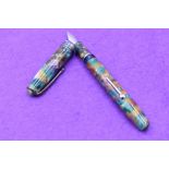 A Conway Stewart 049/500 fountain pen in multi colour marble, lever fill, two narrow and one broad