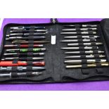 A selection of twenty three fountain, ballpoint and roller ball pens mainly Parker in a soft case