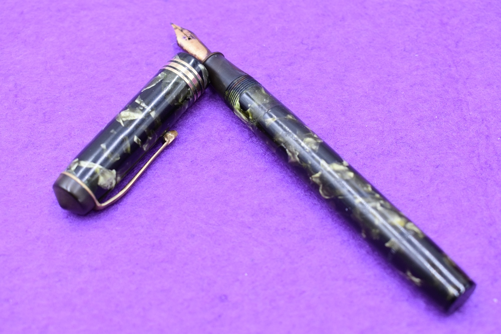 A Conway Stewart 55 fountain pen in green marble, lever fill, two narrow and one broad band to cap