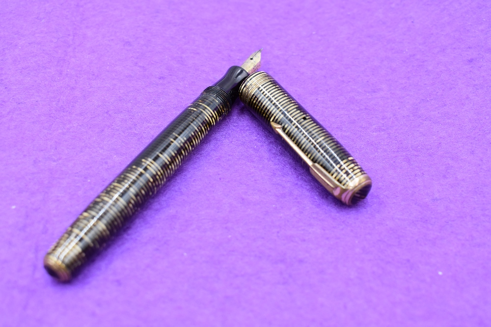 A Parker Vacumatic in brown and gold, three narrow bands to cap