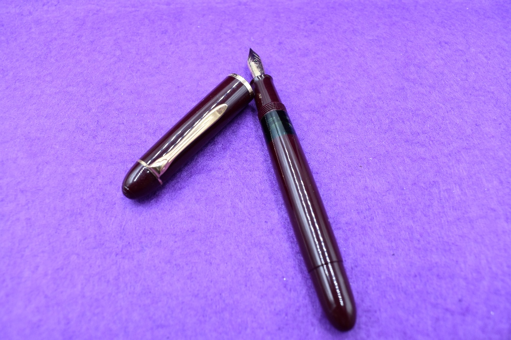 A Pelikan 140 fountain pen, piston fill in burgundy