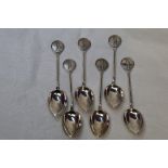 Six 1930's HM silver teaspoons having moulded golf scenes to terminals
