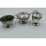 A three piece silver cruet set of Artisan style having silver wire and rose appliqué decoration,
