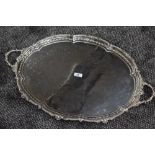 A Victorian silver butler's tray of oval form having moulded handles, moulded decoration to raised