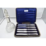 A cased set of six silver handled butter knives of plain form, Sheffield 1915, Allen & Darwin, and a