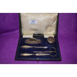 A cased five piece manicure set having silver handles of plain form, Birmingham 1921, Turner &