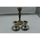 A pair of silver candle sticks of squat form, Birmingham 1976, W I Broadway, and a single silver