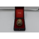 A cased Stuart Devlin 1977 silver gilt limited edition surprise Easter egg having a textured