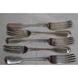 Five Victorian silver table forks of fiddle back pattern bearing crests to reverse of terminals,