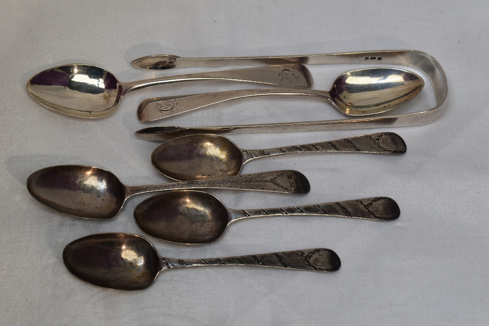 A selection of Georgian silver including teaspoons and a pair of sugar nips of plain form