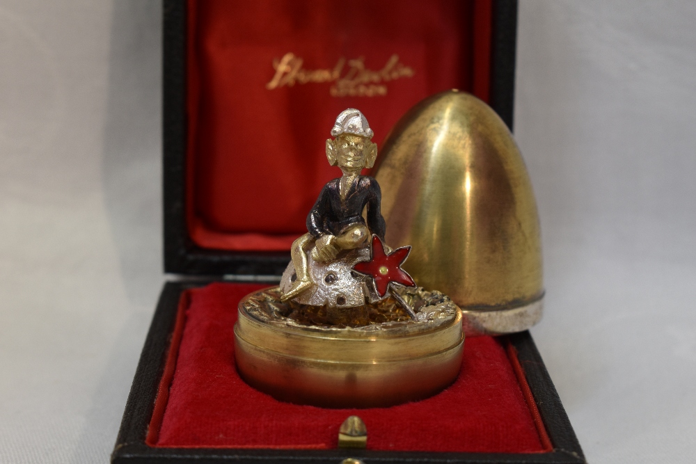 A cased Stuart Devlin 1975 silver gilt limited edition surprise Easter egg having a polished