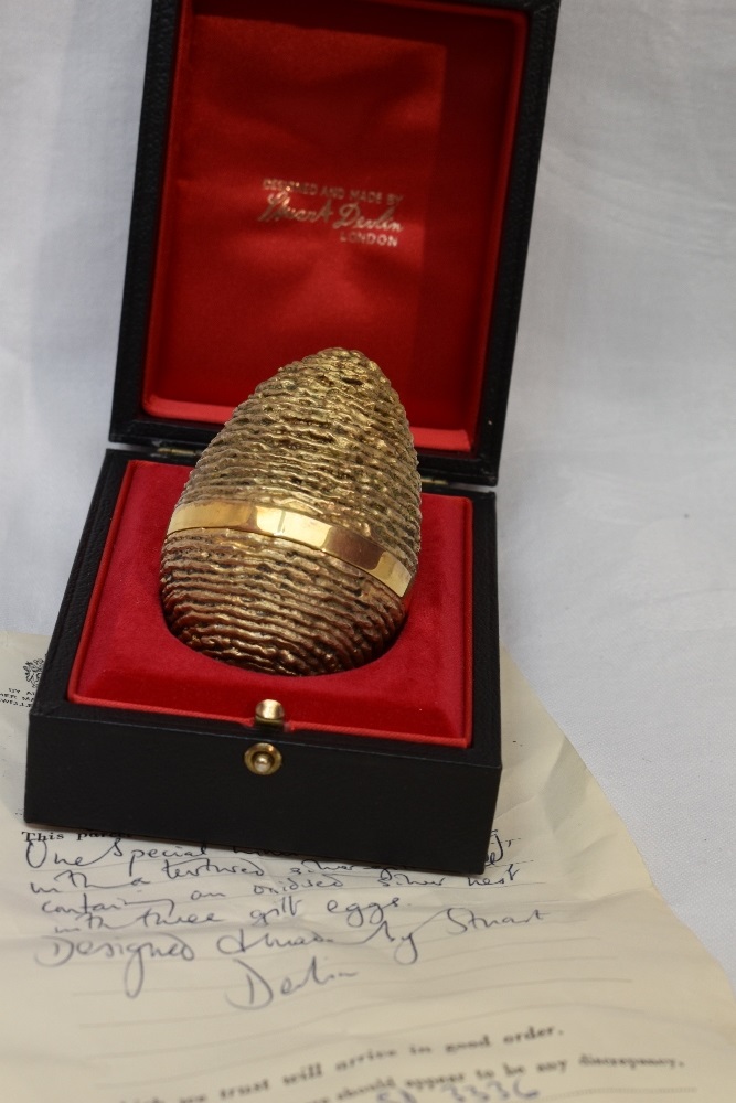 A cased Stuart Devlin 1971 silver gilt surprise Easter egg having a textured exterior opening to