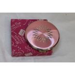 A 1960's silver powder compact by Kigu having cut decoration to pink ground, with original box,