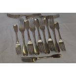 Twelve Georgian silver table and dessert forks (7 & 5) of fiddle back form bearing crests or