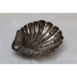 A small Victorian silver butter dish of scallop shell form having floral engraved decoration and