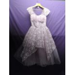 Vintage 1950s lilac and silver gown having layers of tulle over an integrated underskirt. Back metal