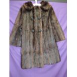 A vintage 1950s/1960s glossy dark brown mink coat having pockets to sides and large cord detailed