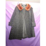 A vintage 1960s astrakhan coat having mink collar and pockets to sides,fully lined, great