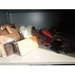 A large selection of vintage and modern handbags and purses, mixed styles and eras. Some wear to a