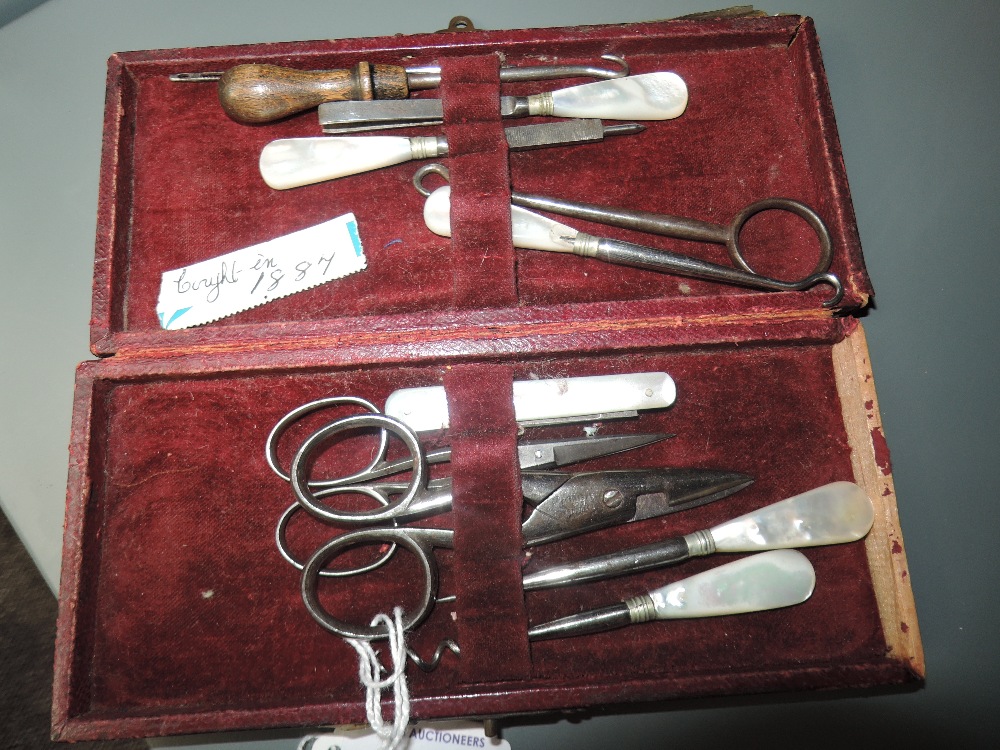 A Late 19th century manicure set containing scissors , button hooks and similar, five items having