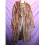 A stunning brown mink coat having large collar, pockets to sides and internal tie to waist. Fully