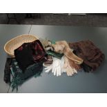 A basket of mixed vintage items, shawls, gloves and belts and fur items including a hat two