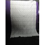 A large vintage knitted white bed covering, intricate detailing throughout. believed by vendor to be