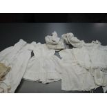 A collection of childrens clothing and dolls clothes. Mostly around late 19th early 20th century.