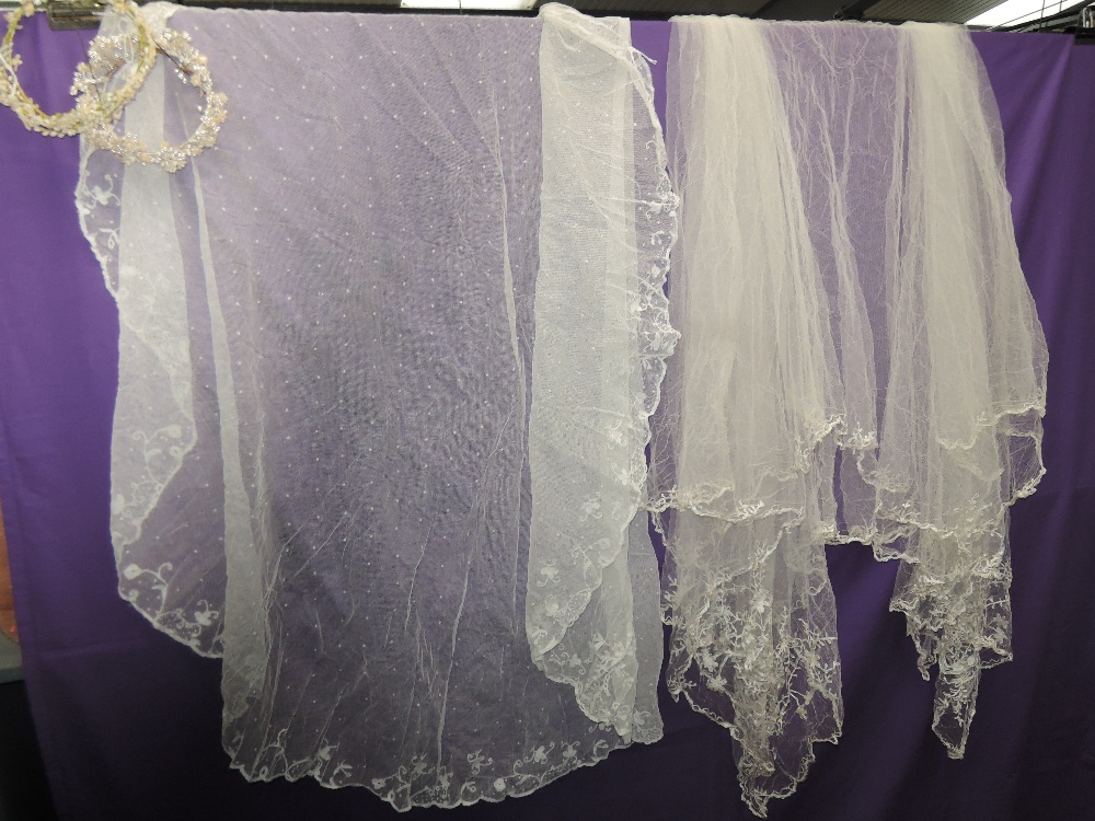 Two ornate tulle and lace Veils and two head dresses having wax flower decoration.