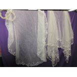 Two ornate tulle and lace Veils and two head dresses having wax flower decoration.