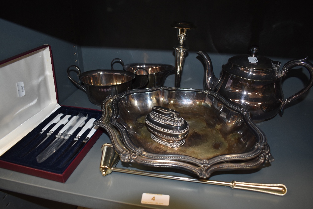 A selection of plated metal wares including graduated trays and part L R S tea set