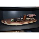 A radio controlled battery operated wood and plastic hand built model boat, named African Queen