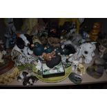 A variety of animal figurines, from dogs,birds and zebras to hedgehogs badgers and rabbits! A good
