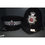 A police helmet and similar hat, having Lancashire constabulary badges.