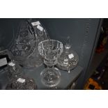 A selection of clear cut crystal glass wares including sugar sifter and candle stem