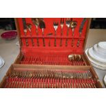 A canteen of retro cutlery, in a brass gilt or similar, having a bamboo effect design.