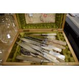 A decorative wooden cutlery box having green and floral silk and green velvet lining, with a good