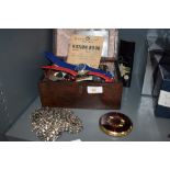 An antique wooden box containing an array of vintage odds and ends, including some lead animals/