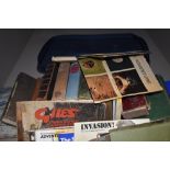 A suitcase of vintage and antique books, some having decorative spines, including novels and poetry,