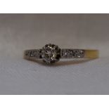 A lady's diamond solitaire dress ring, approx 0.25ct in a decorative claw set mount to diamond set