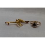 A yellow metal bar brooch stamped 9C having Swallow decoration, (AF) and a lady's dress ring