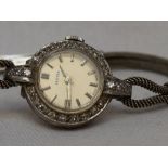 A lady's cocktail watch by Vertex having a baton numeral dial to silvered face within a diamond